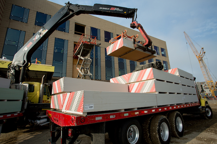 Building materials being delivered to an active commercial construction site